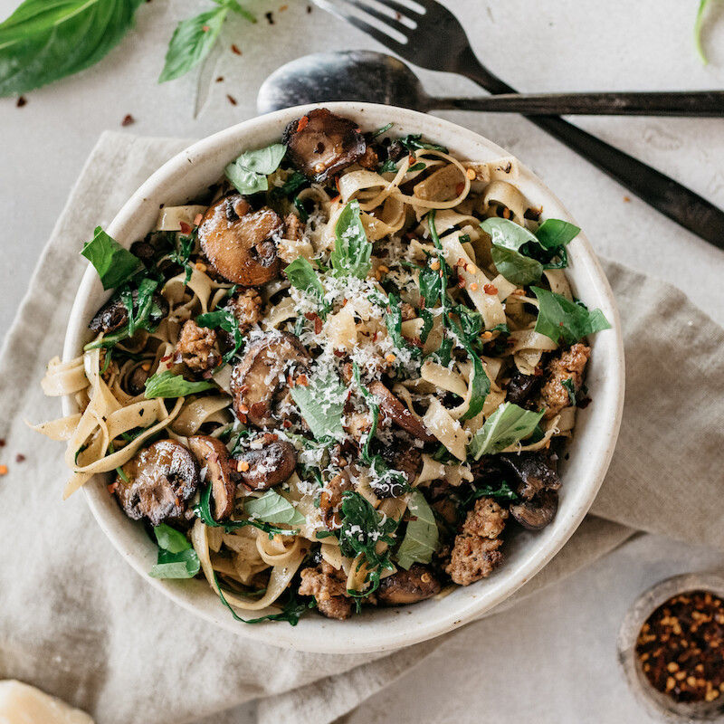 one pot sausage pasta recipe with mushrooms, and arugula