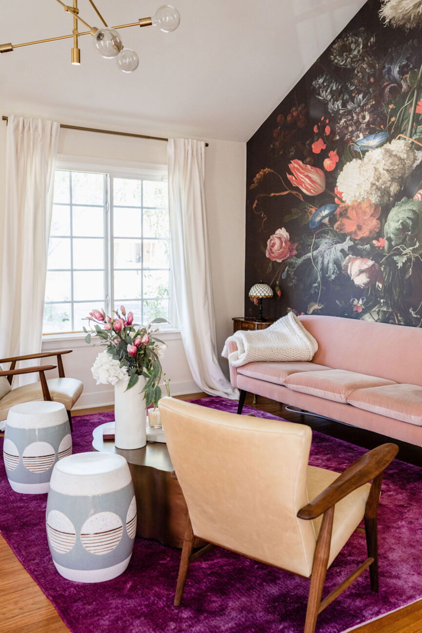 Bright pink couch and armchairs in living room.