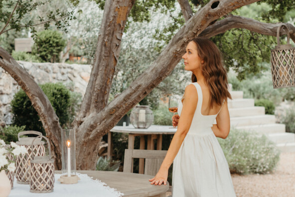 Camille Styles wearing white dress.