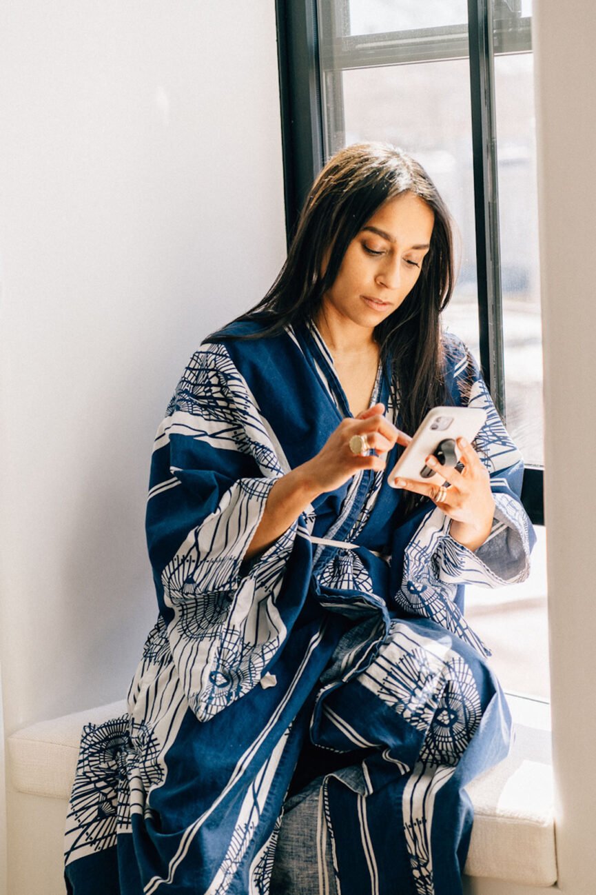 Woman using phone to practice social media boundaries.