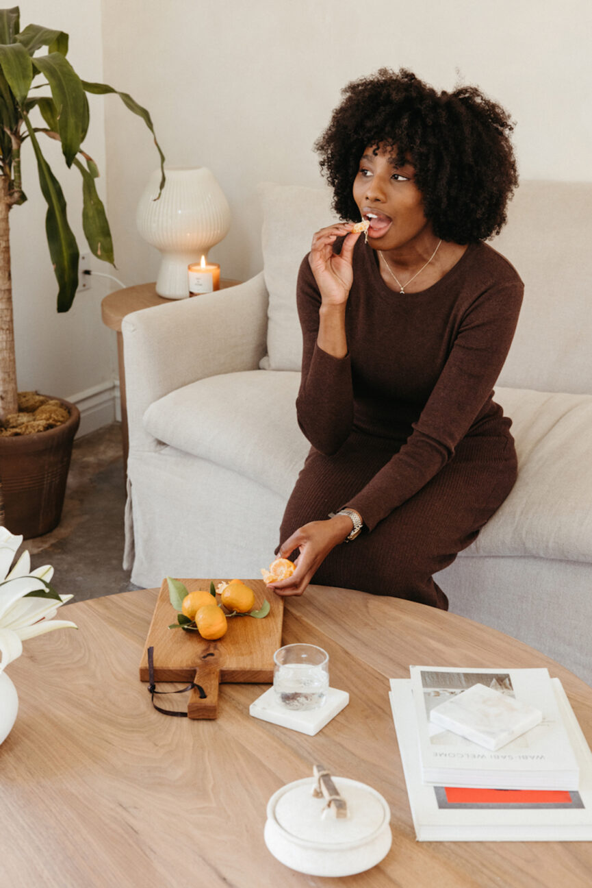 Woman eating orange segments.