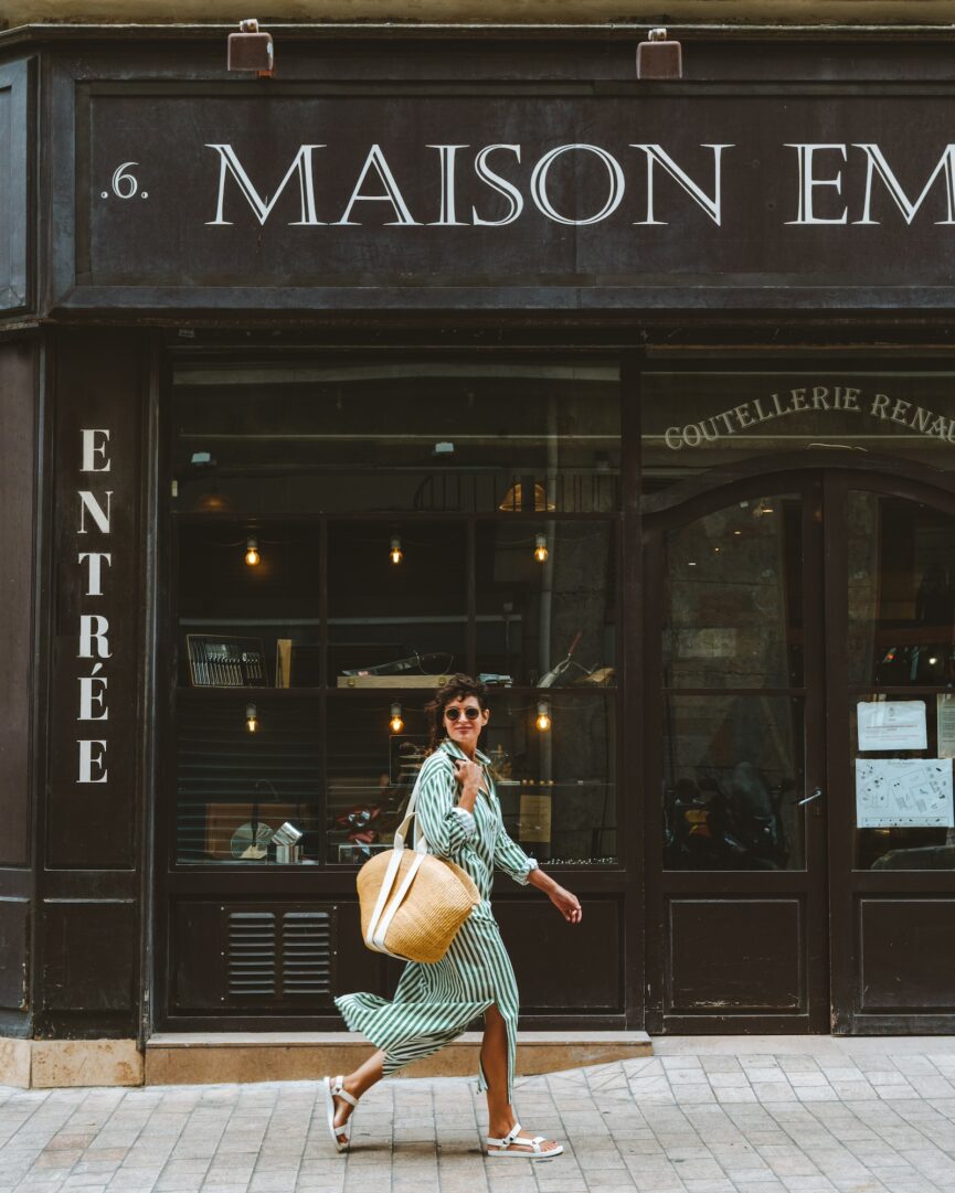 woman walking down street in striped dress